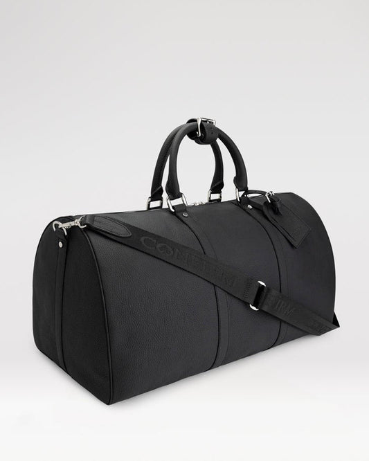 Confirm 55-inch leather travel bag with spade details, travel tag, hand handles, and detachable shoulder strap.